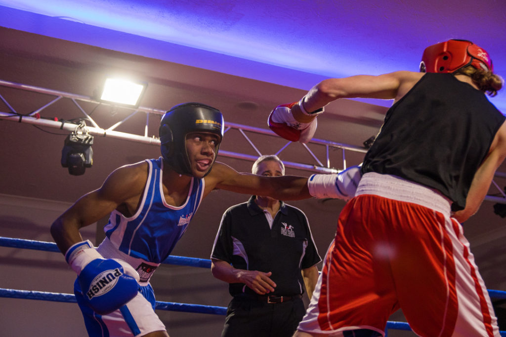 Unorthodox (or left-handed) boxing basics are a bit different than orthodox (right-handed). In this image, the boxer in blue throws a left straight at his opponent and hits him at the hip.